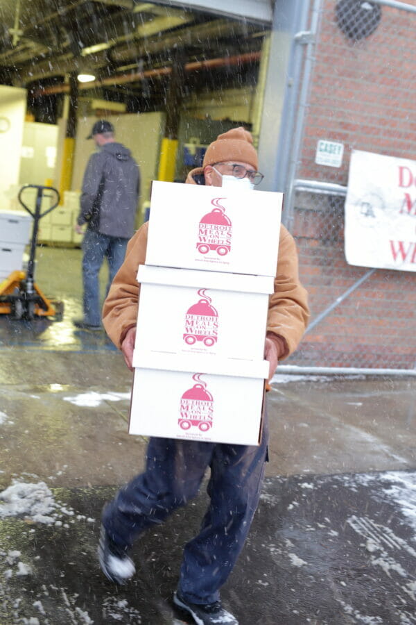 Volunteer carrying boxes